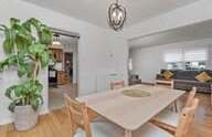Dining area with a pendant light and big windows