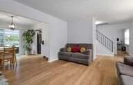 Living room with wood floors and a staircase