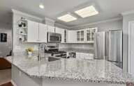 Kitchen with granite counters and white cabinets